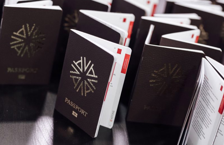 passport type documents standing upright on a wooden office table with the brand logo and insignia of Astons