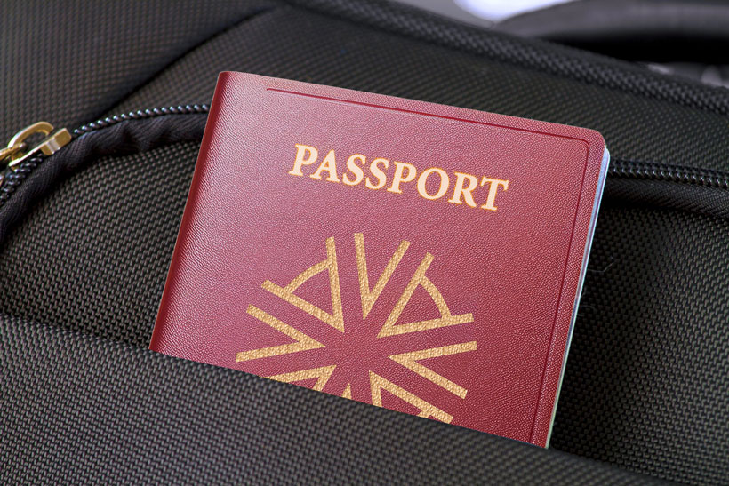 red passport in a black leather attache case with the logo and brand name of Astons